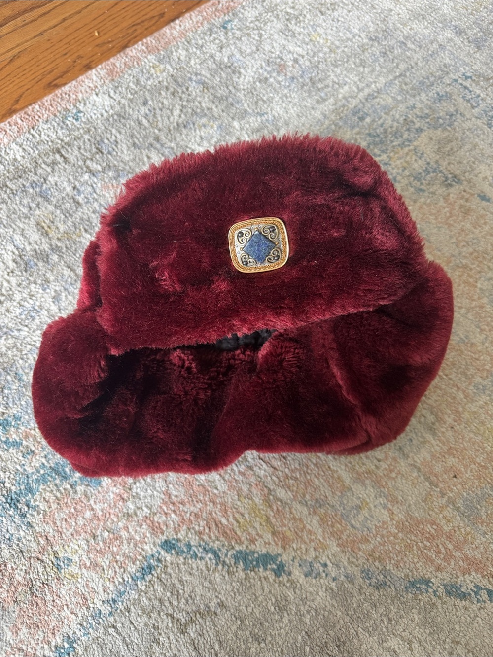 Plush Faux Fur Hat in Deep Burgundy with Decorative Medallion
